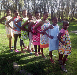 African children show off their dresses created by "Sew Much Fun" club.