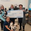 Lisa Cox presents $1000 grant check to April Smith